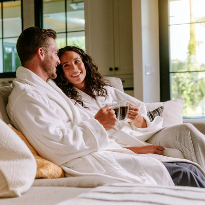 Couple sitting on couch in kimono robes